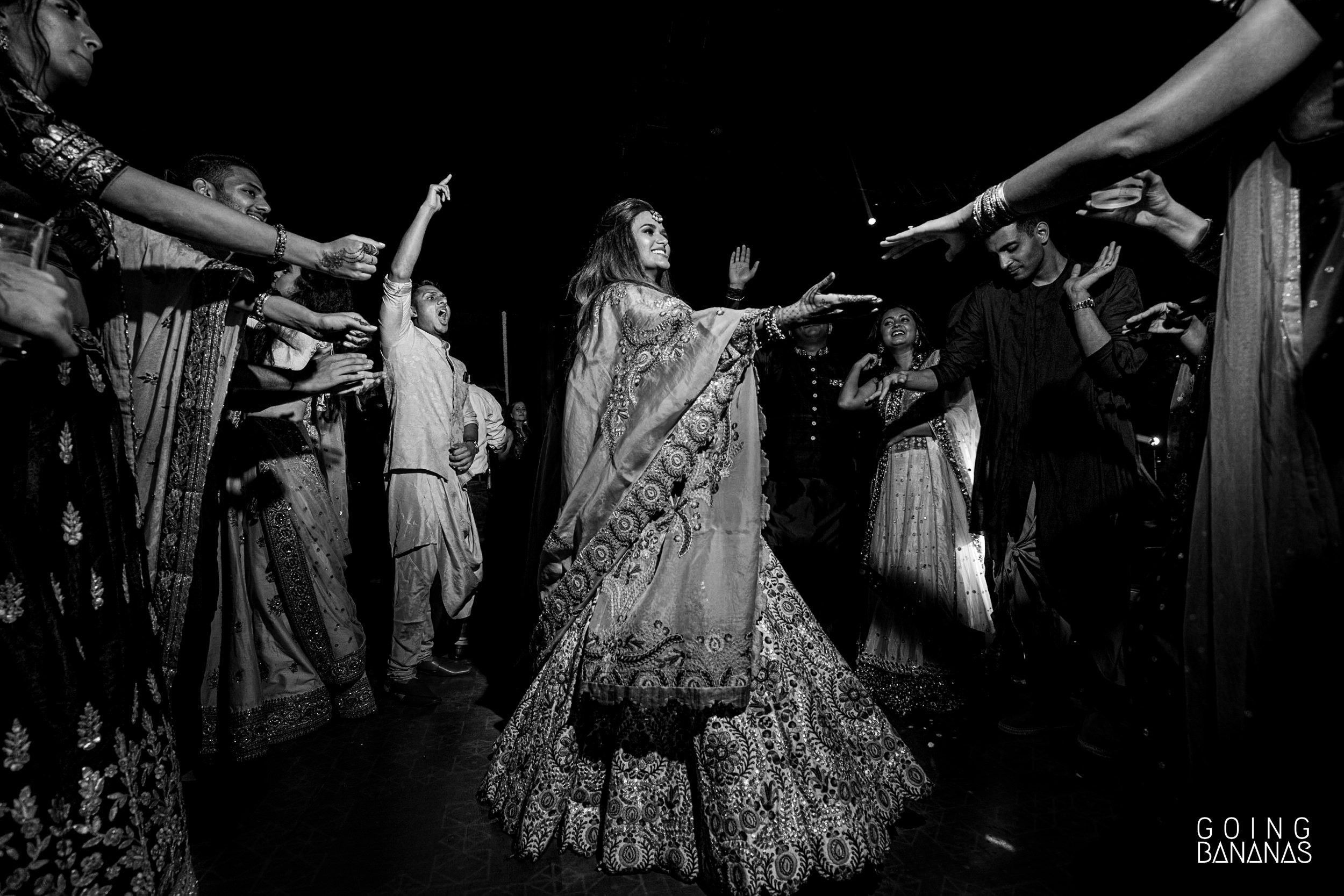 Bride pulling in a friend to the dance floor at Taj Aravali Udaipur