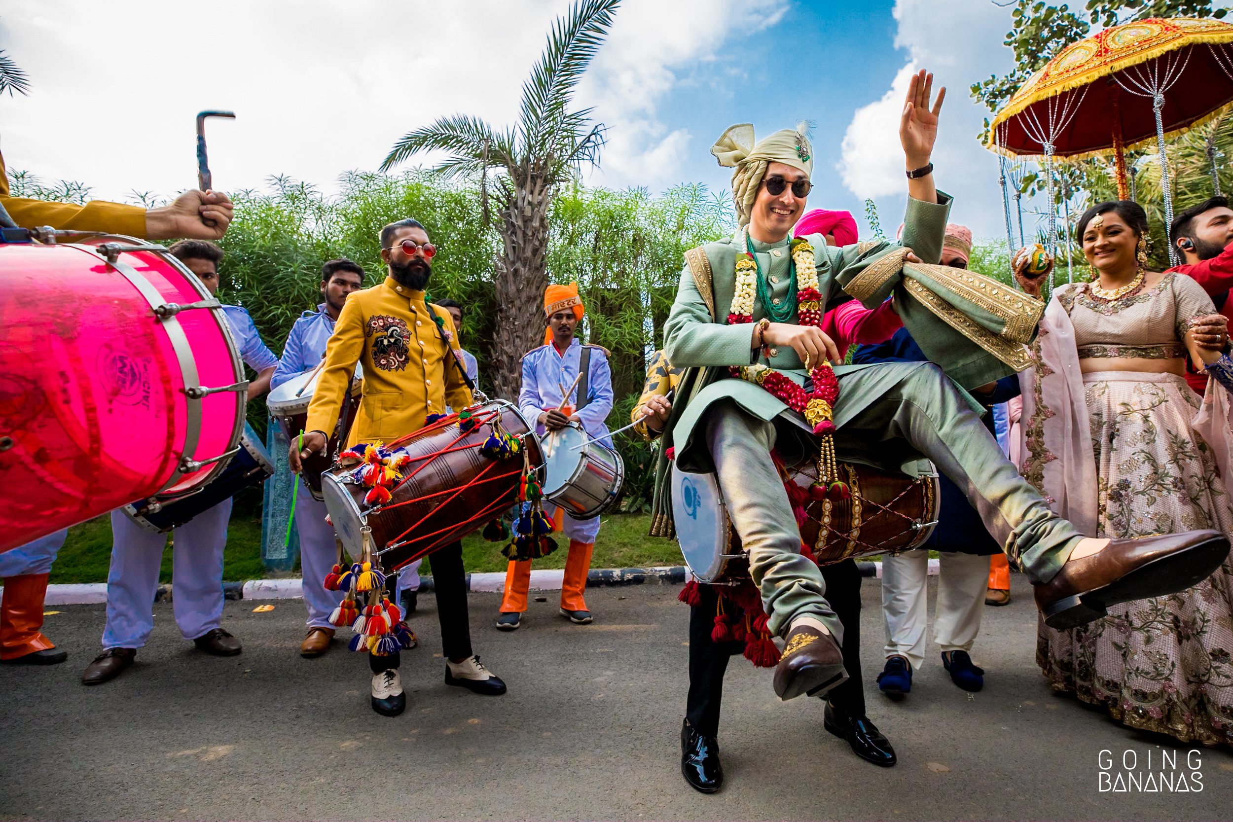 Groom in Sabyasachi at the baraat sitting on a dhol