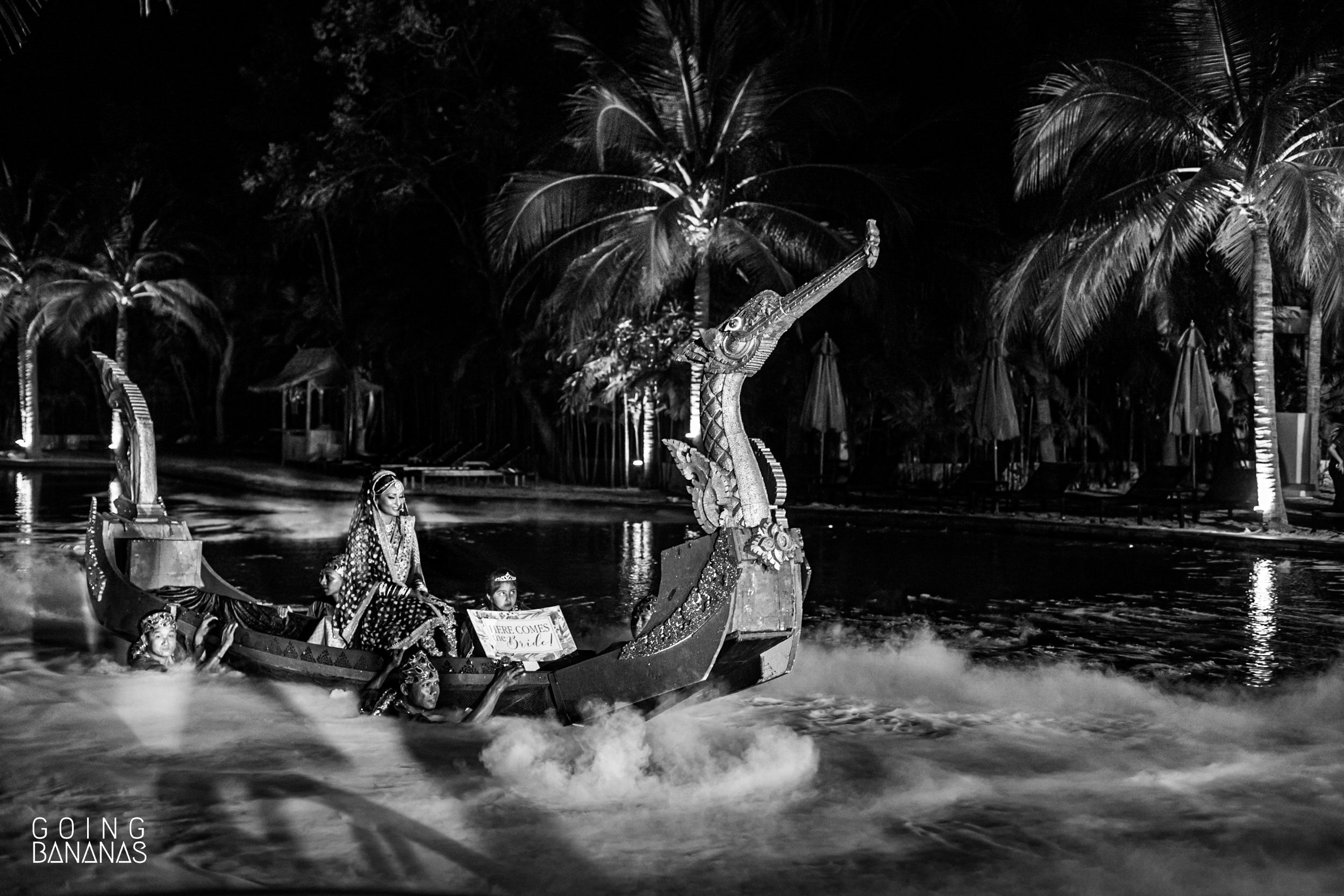 Bride making an entry on a boat in the swimming pool at Marriott Rayong Thailand