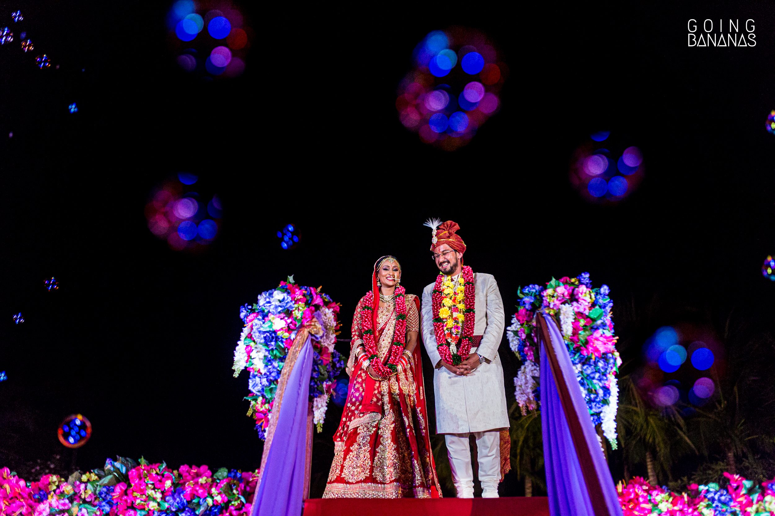 Bride and groom after the varmala or jai mala surrounded by bubbles