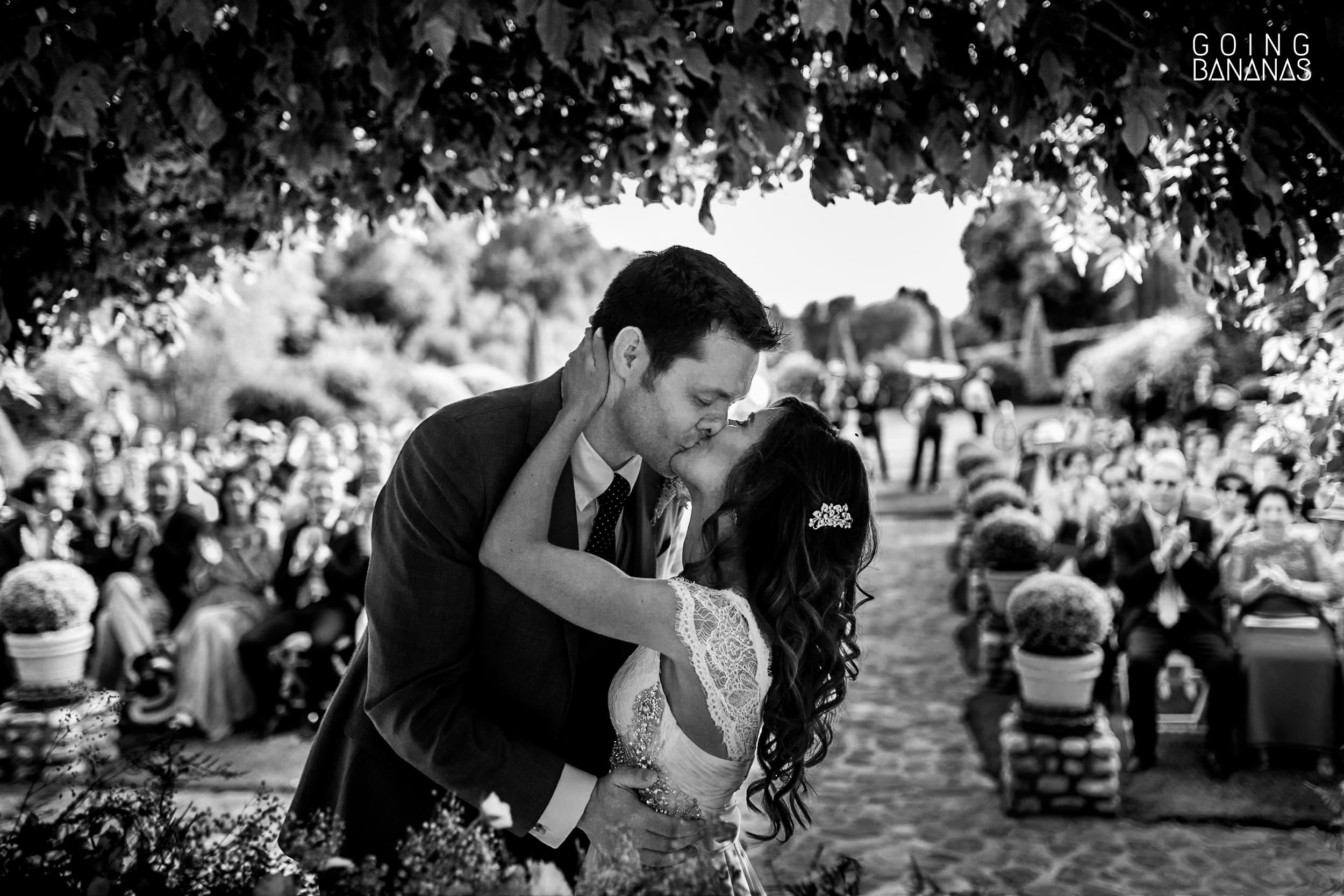 Bride and groom kissing at the wedding ceremony at Antigua Fábrica de Harinas
