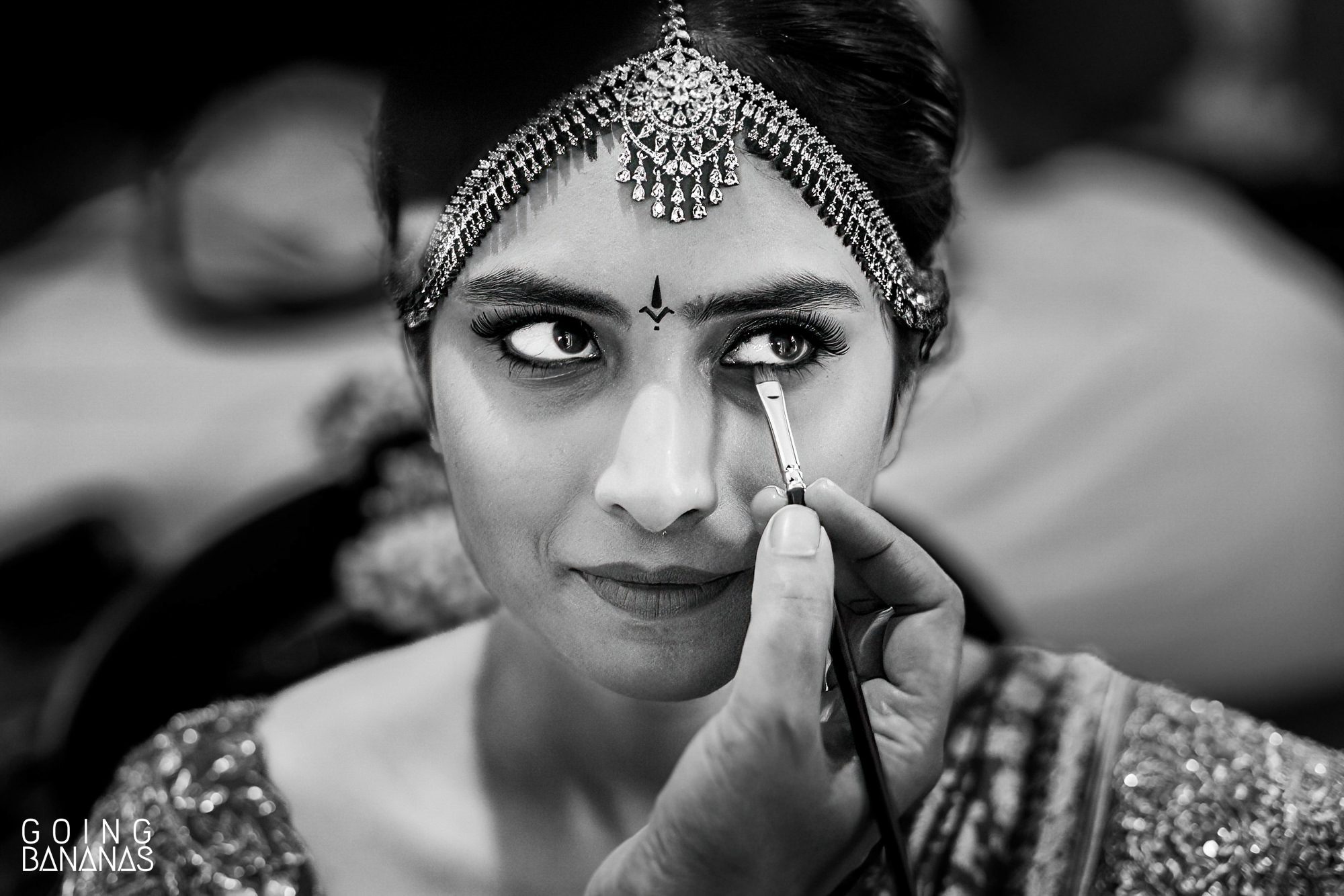 Telegu bride getting finishing touches of makeup in her room at Taj Exotica Goa